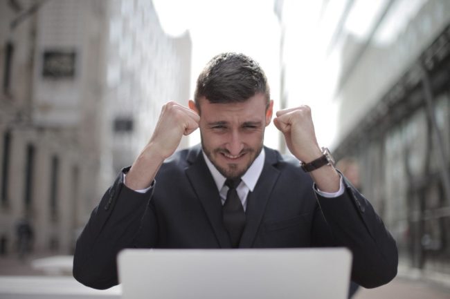 man in black suit achieved an accomplishment