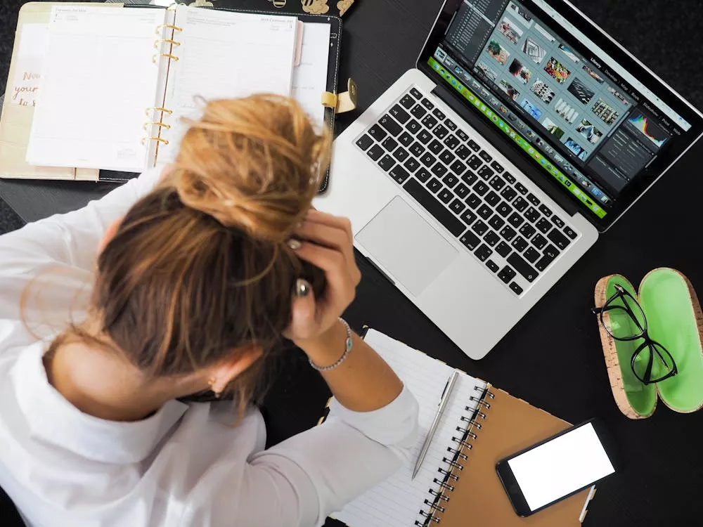 Stressed woman behind laptop